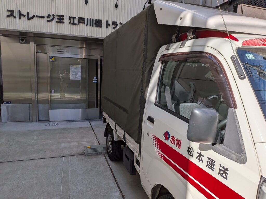 トランクルーム前に停車した赤帽松本運送の幌トラックの様子