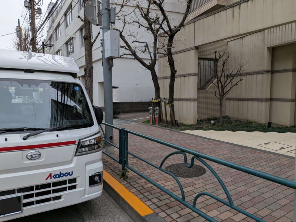 豊島区マンション前で積込み準備中の赤帽松本運送トラック