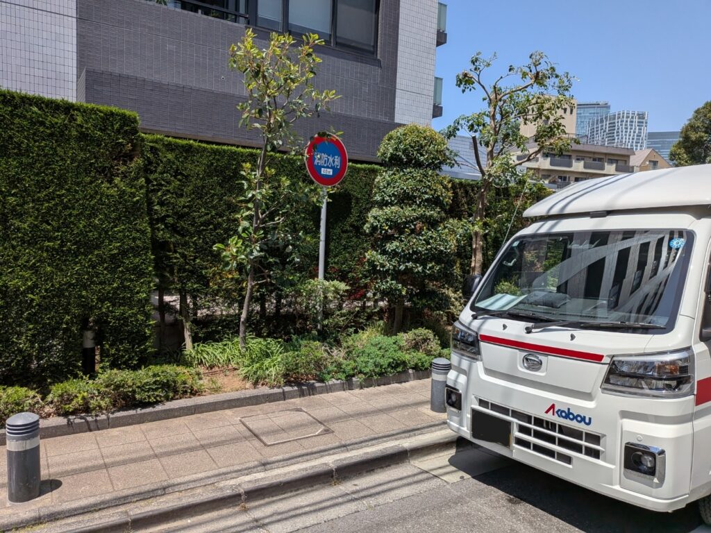 渋谷区のマンション前に停車した赤帽松本運送トラック