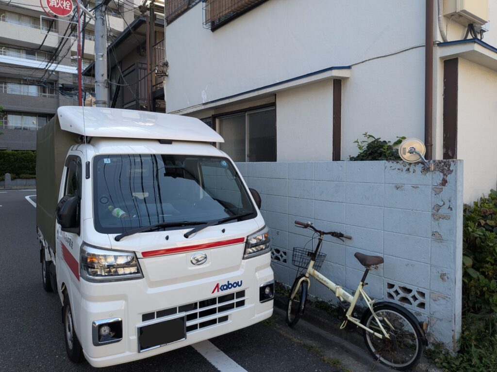 板橋区内のアパート前に到着した赤帽松本運送のトラック